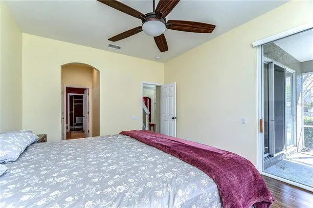 a bedroom with a bed and a large mirror