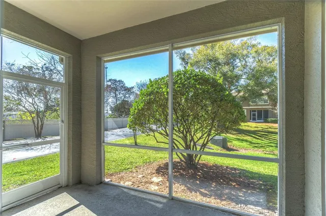 a view of a porch with two chairs in a yard