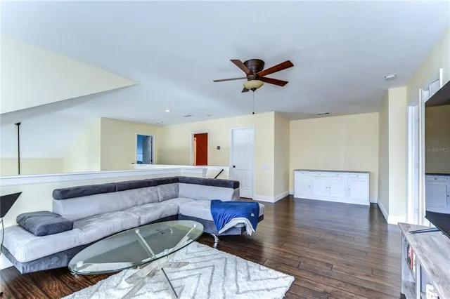 a living room with furniture and a wooden floor