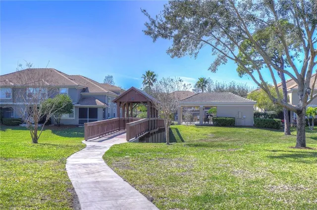 a front view of house with outdoor space and trees
