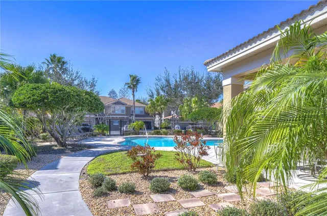 a swimming pool with outdoor seating and yard