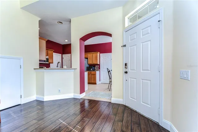 a view of a room with wooden floor and entryway