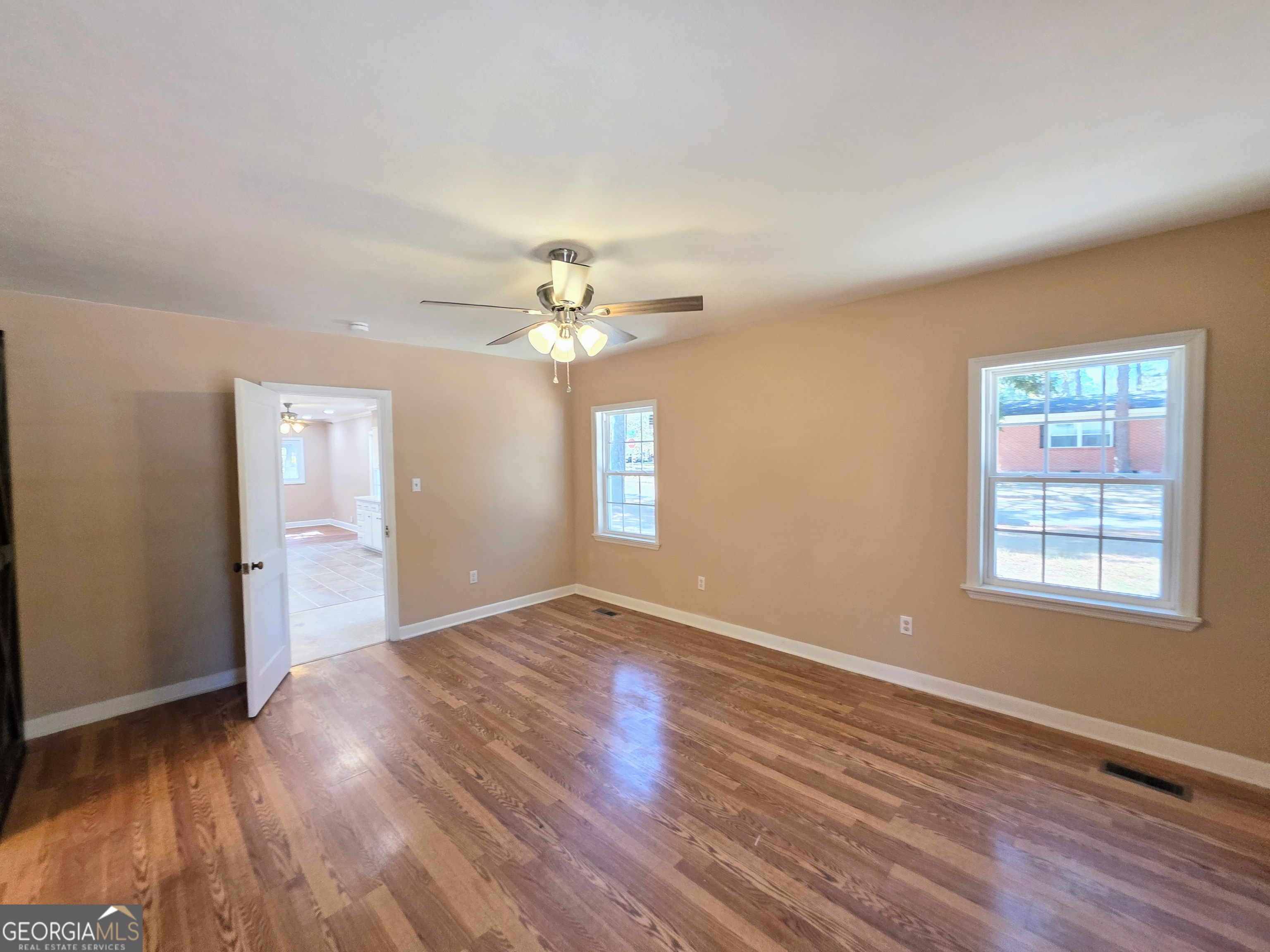 723 10th Avenue Albany, GA 31701 - Photo 18 of 23 a view of an empty room with wooden floor and a window