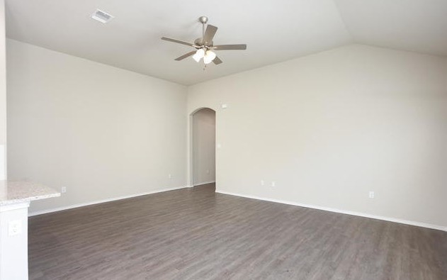 3414 Scott Circle Seguin, TX 78155 - Photo 9 of 12 Unfurnished room with vaulted ceiling, arched walkways, dark wood finished floors, and ceiling fan