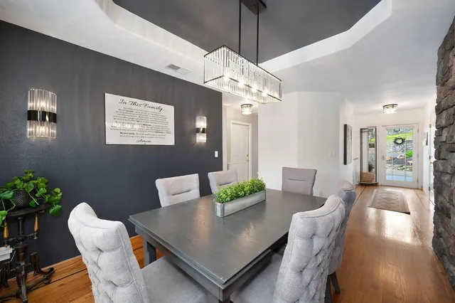 a kitchen with white cabinets and sink
