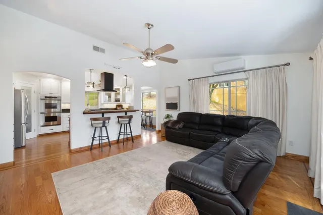 a bathroom with a toilet a sink and glass door