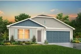 a front view of yellow house with a yard