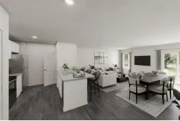 a living room with furniture a flat screen tv and a refrigerator