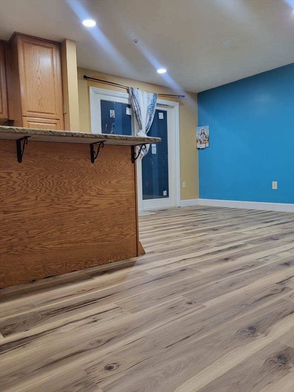 70 Broadway, Unit 24 North Attleboro, MA 02760 - Photo 2 of 10 a view of a hallway with wooden floor and a window