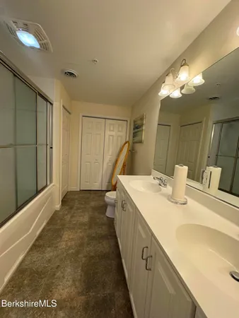 a bedroom with a bed and lamp