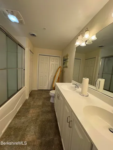 a bedroom with a bed and lamp