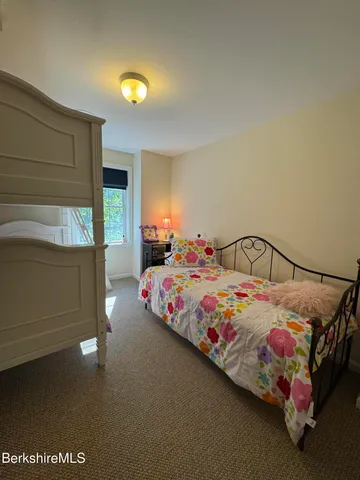 a bedroom with a bed and flat screen tv