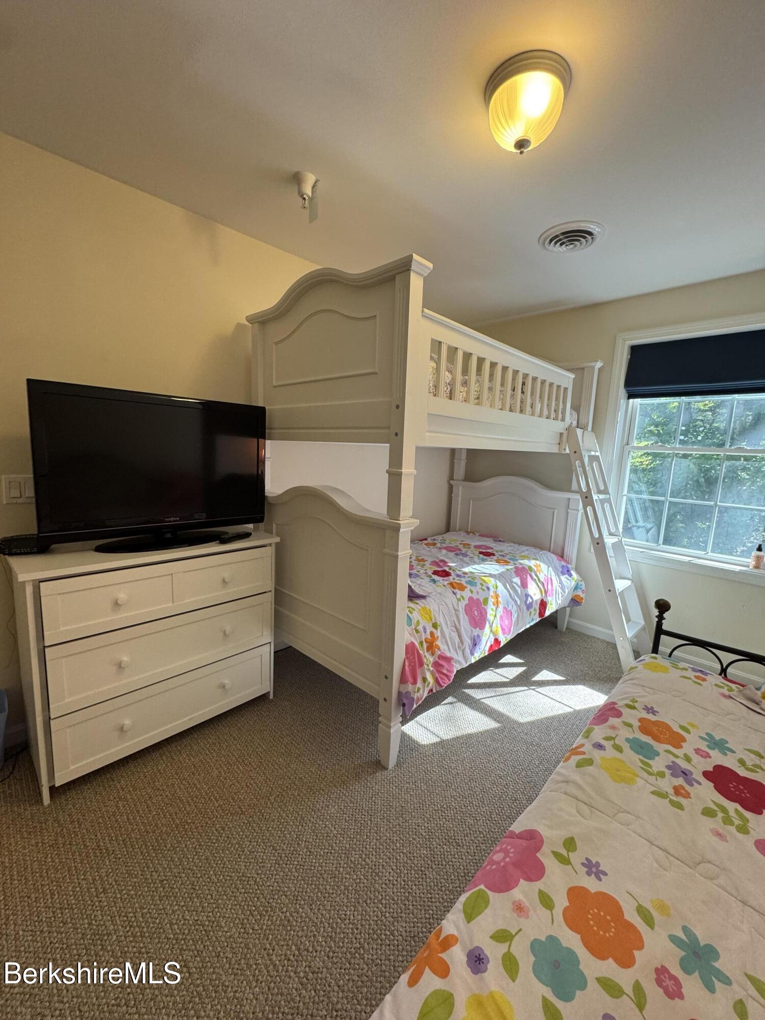 37 Corey Road, Unit 862 Hancock, MA 01237 - Photo 15 of 27 a bedroom with a bed and flat screen tv