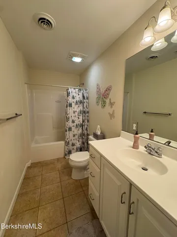 a bedroom with furniture and a lamp