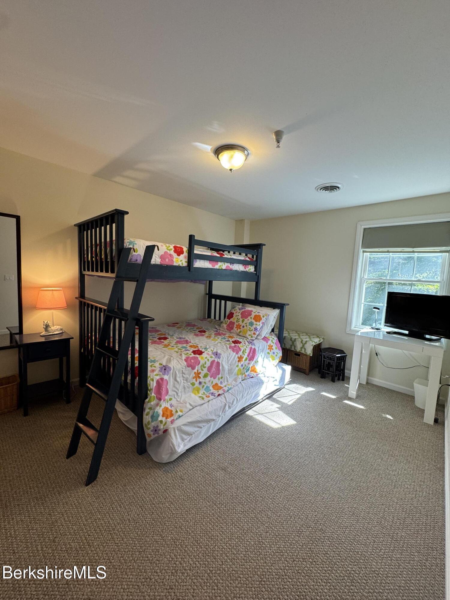 37 Corey Road, Unit 862 Hancock, MA 01237 - Photo 17 of 27 a bedroom with furniture and a lamp