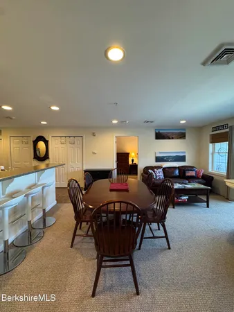 a view of a balcony with wooden floor and outdoor seating