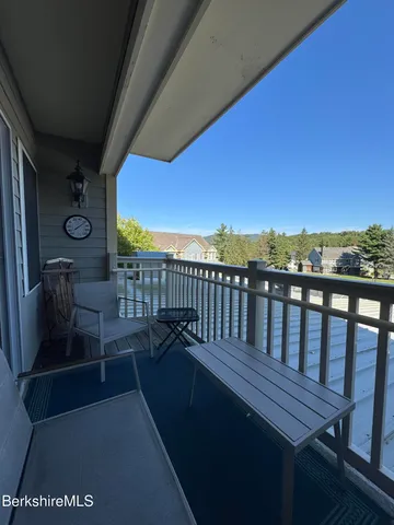 a view of a balcony with wooden floor and outdoor space