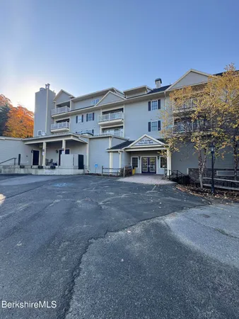 a view of a big house with a street