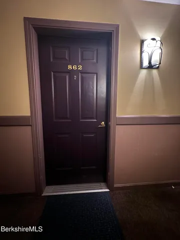 a large kitchen with a counter top space a sink a stove and a refrigerator