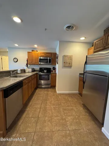 a view of a living room and kitchen