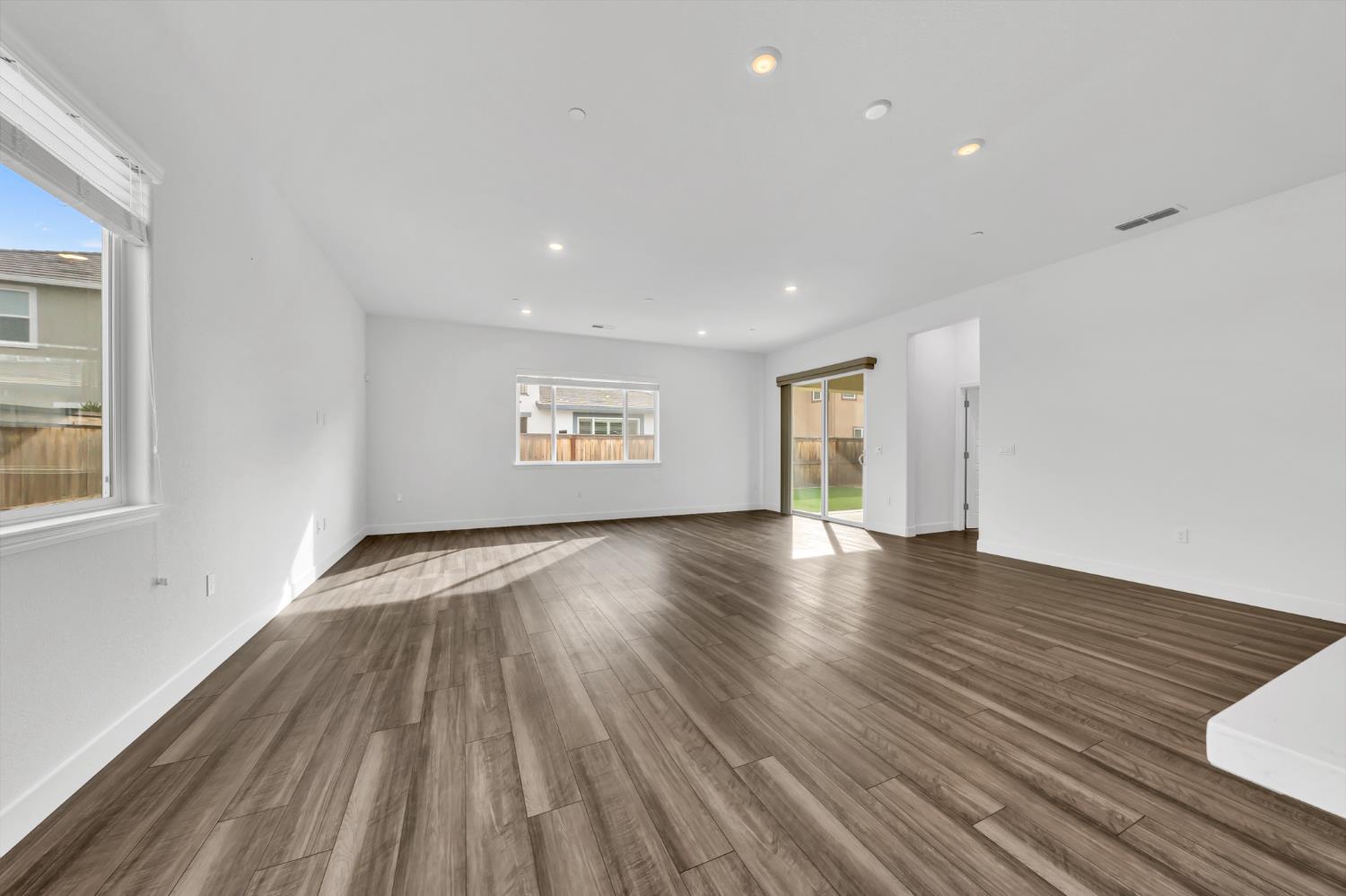 4236 Bellwether Way Sacramento, CA 95835 - Photo 12 of 46 a view of an empty room with a window and wooden floor