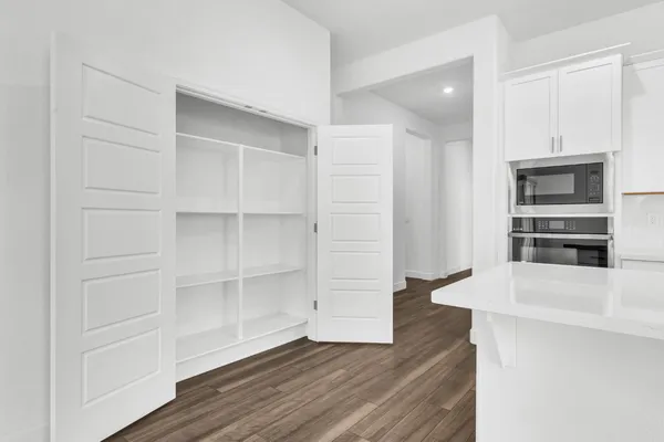a view of walk in closet with empty racks