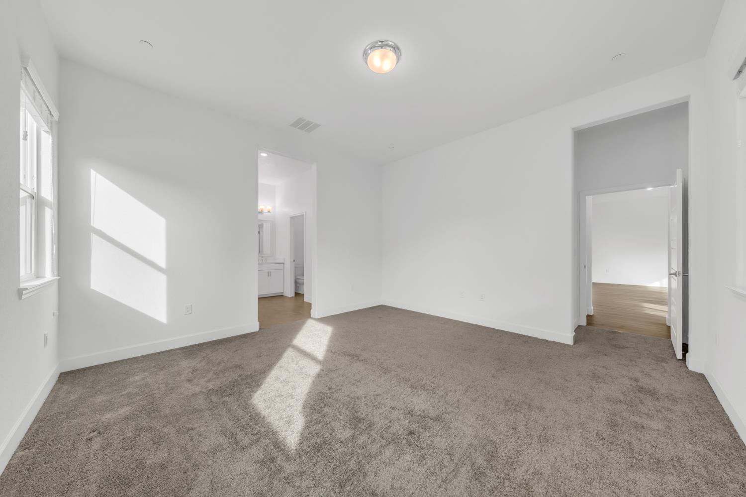 4236 Bellwether Way Sacramento, CA 95835 - Photo 19 of 46 an empty room with windows and entrance to other room
