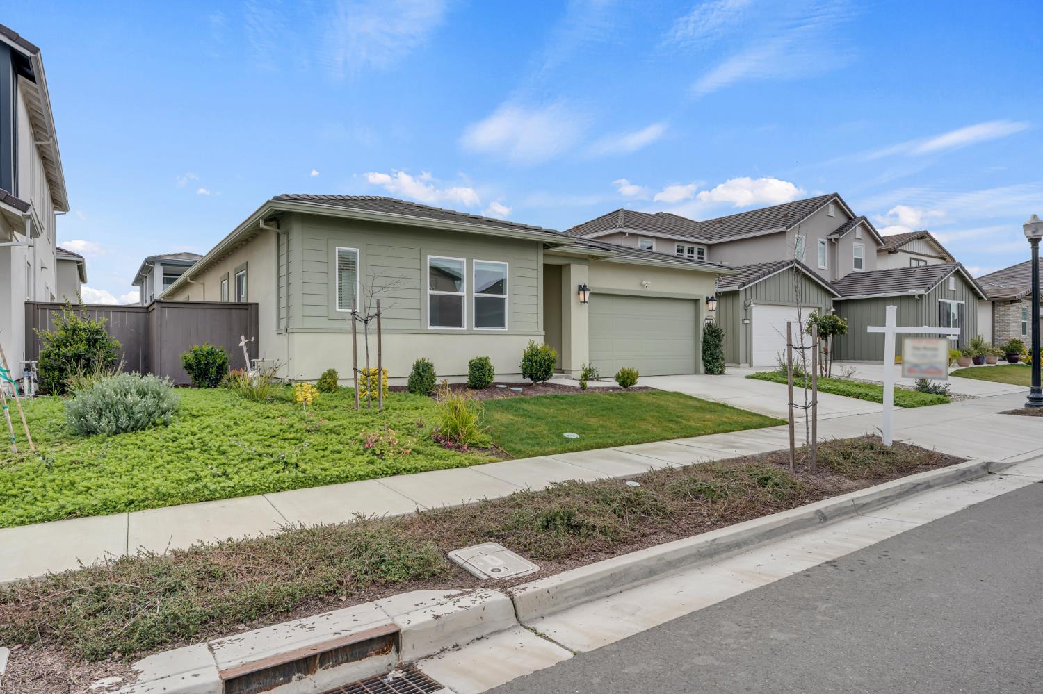 4236 Bellwether Way Sacramento, CA 95835 - Photo 2 of 46 a front view of a house with a yard and garage