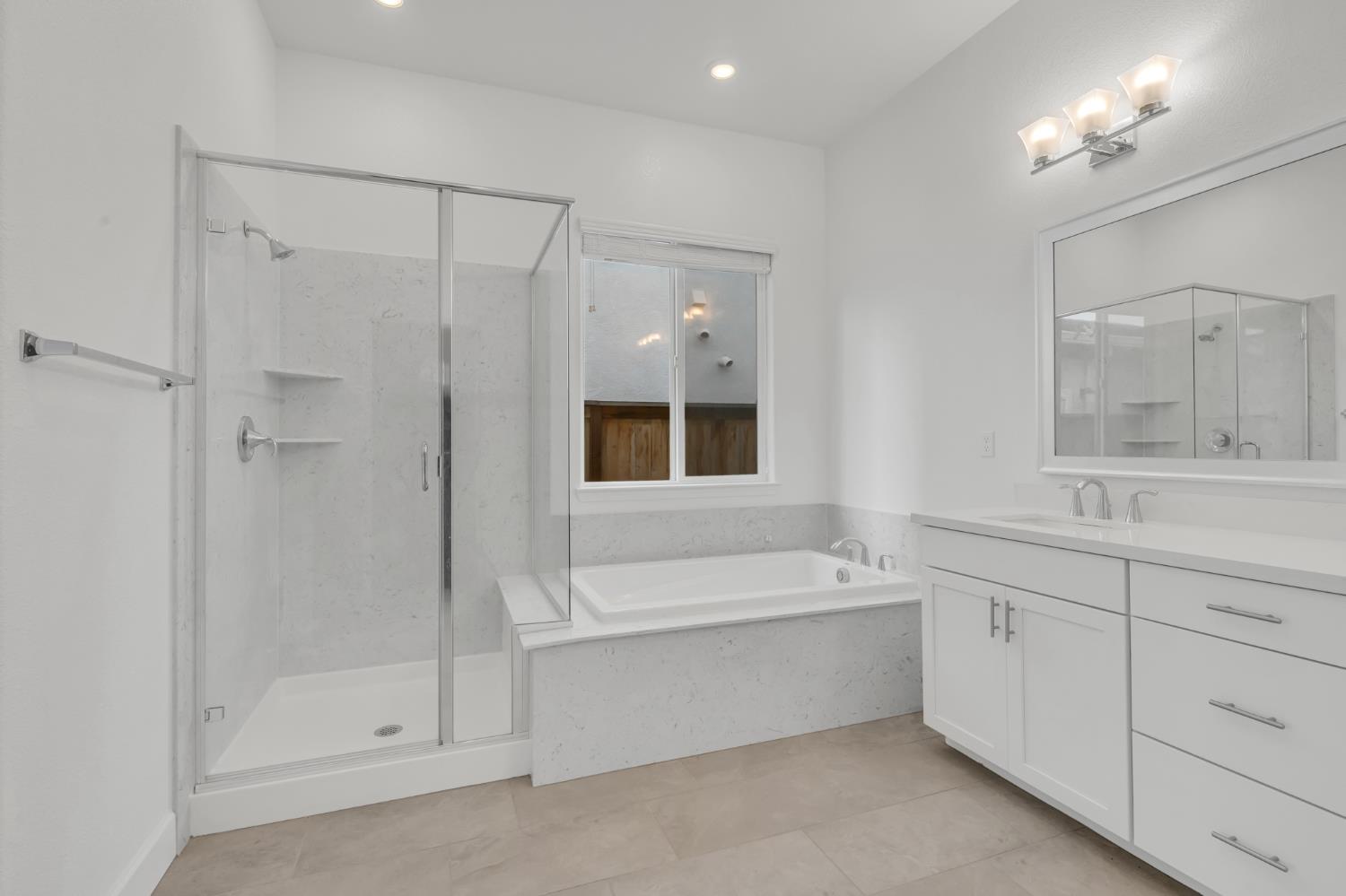 4236 Bellwether Way Sacramento, CA 95835 - Photo 21 of 46 a bathroom with a bathtub a shower a sink and a window