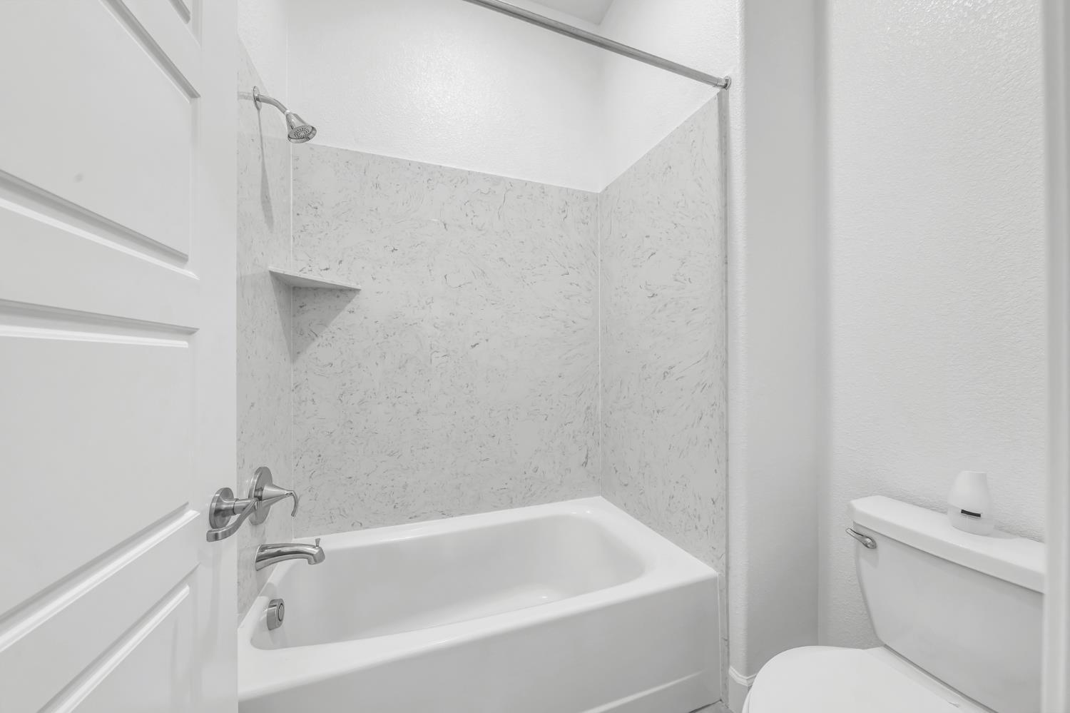 4236 Bellwether Way Sacramento, CA 95835 - Photo 31 of 46 a white bath tub sitting next to a white toilet