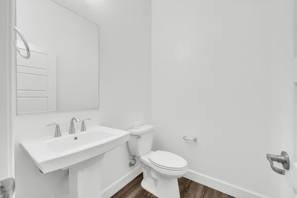 a bathroom with a sink a toilet and mirror