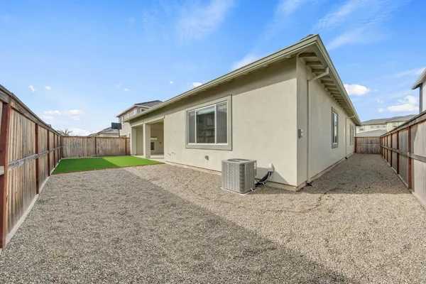 a view of a backyard with wooden floor and fence