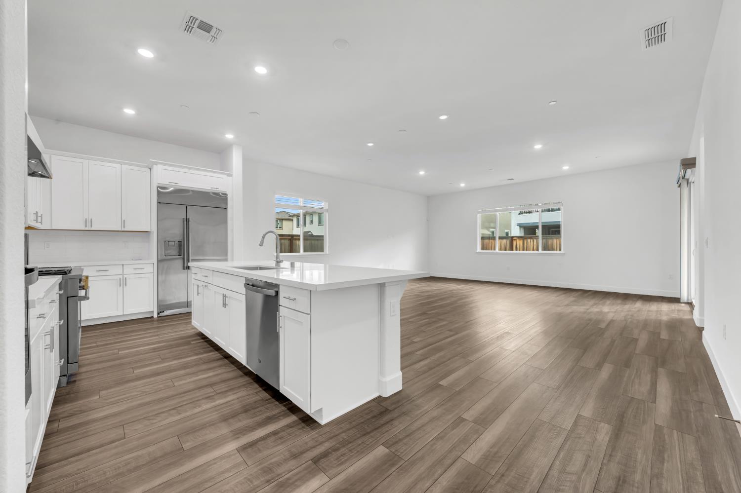 4236 Bellwether Way Sacramento, CA 95835 - Photo 5 of 46 a kitchen with kitchen island wooden floors appliances and cabinets