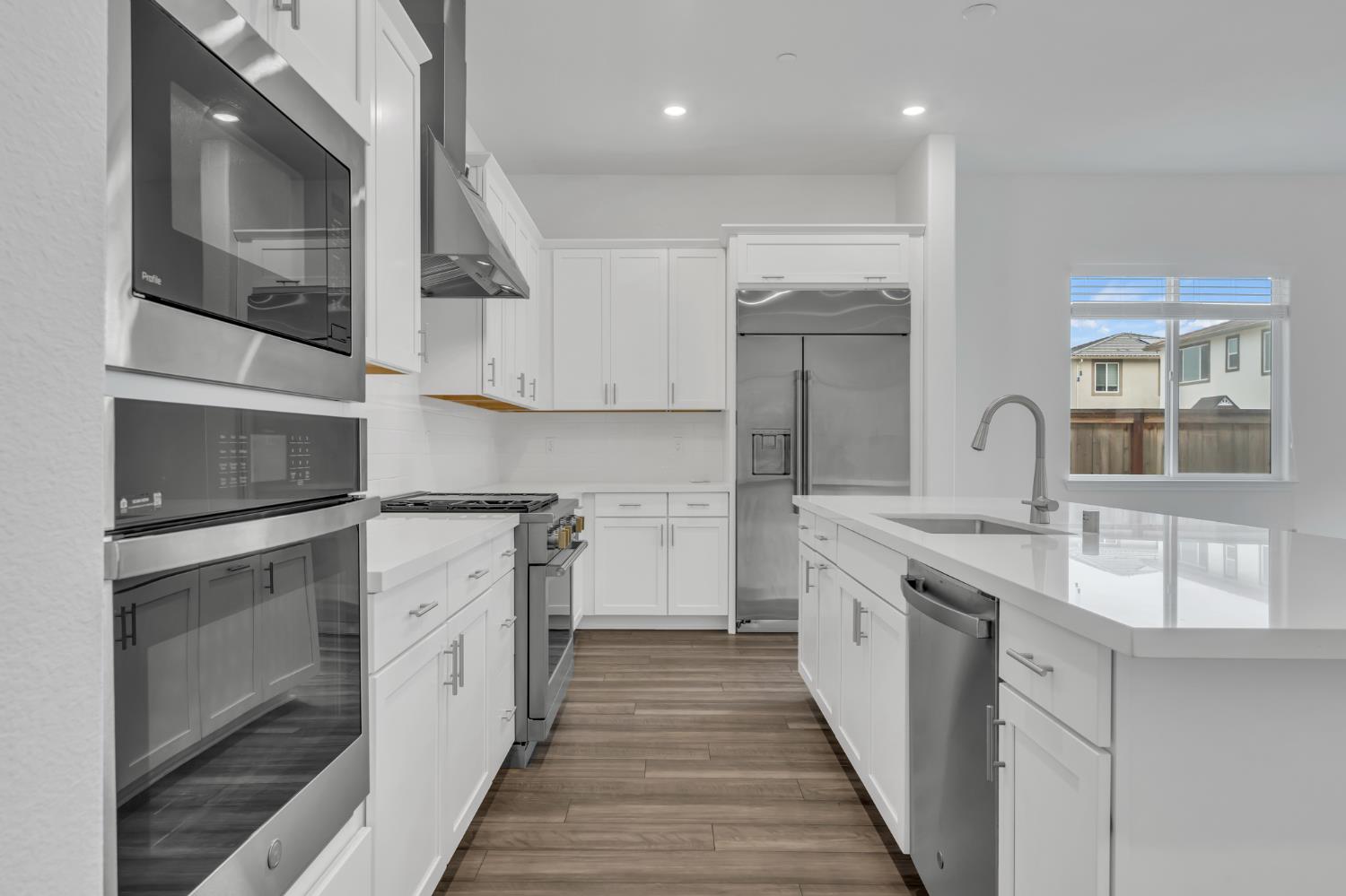 4236 Bellwether Way Sacramento, CA 95835 - Photo 6 of 46 a kitchen with stainless steel appliances granite countertop a sink and cabinets