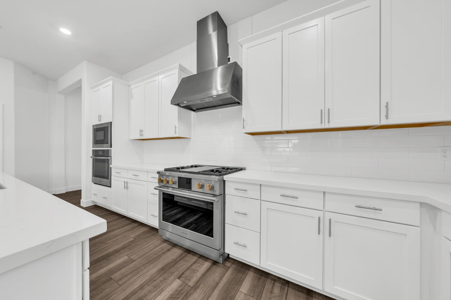 4236 Bellwether Way Sacramento, CA 95835 - Photo 8 of 46 a kitchen with white cabinets and a stove