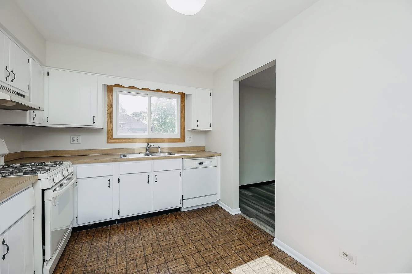 865 Sheldon Court, Unit C Wheaton, IL 60189 - Photo 5 of 11 a kitchen with granite countertop white cabinets and white appliances