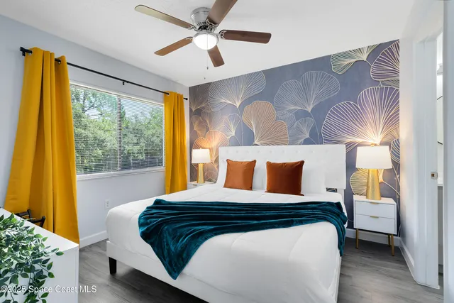 a bedroom with a large bed and a window