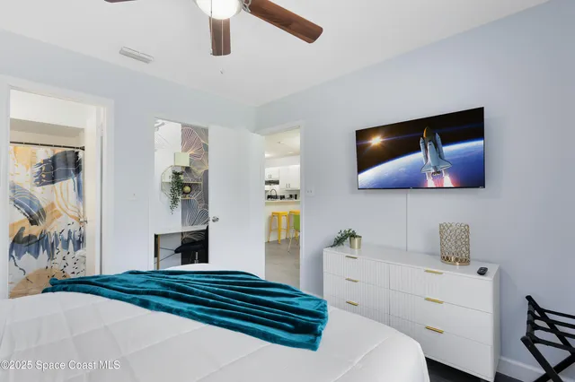 a bedroom with a bed and a flat screen tv