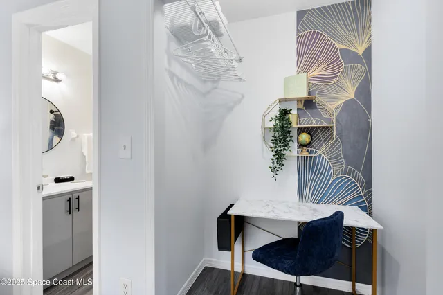 a view of entryway and hall with wooden floor