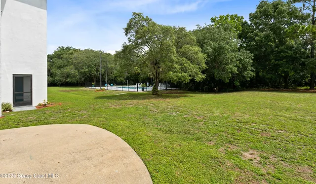 a front view of a house with a garden and plants