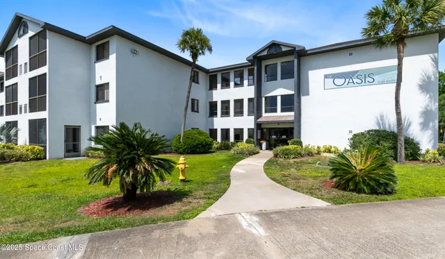a group of people sitting in front of retail shop