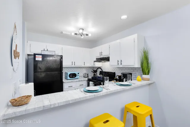 a kitchen with a refrigerator and microwave