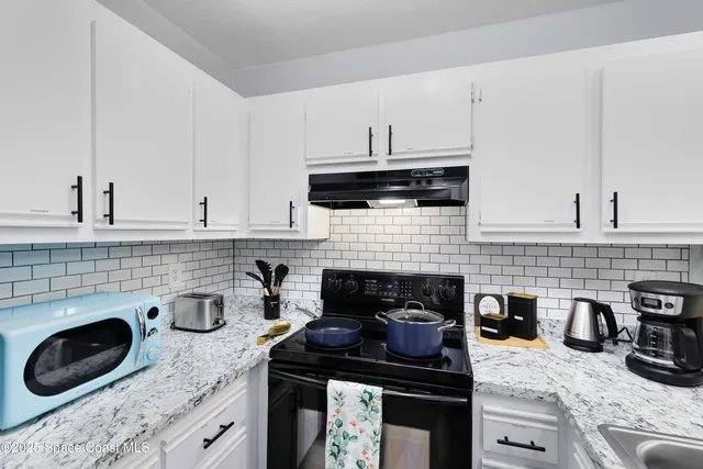 a kitchen with a stove and cabinets