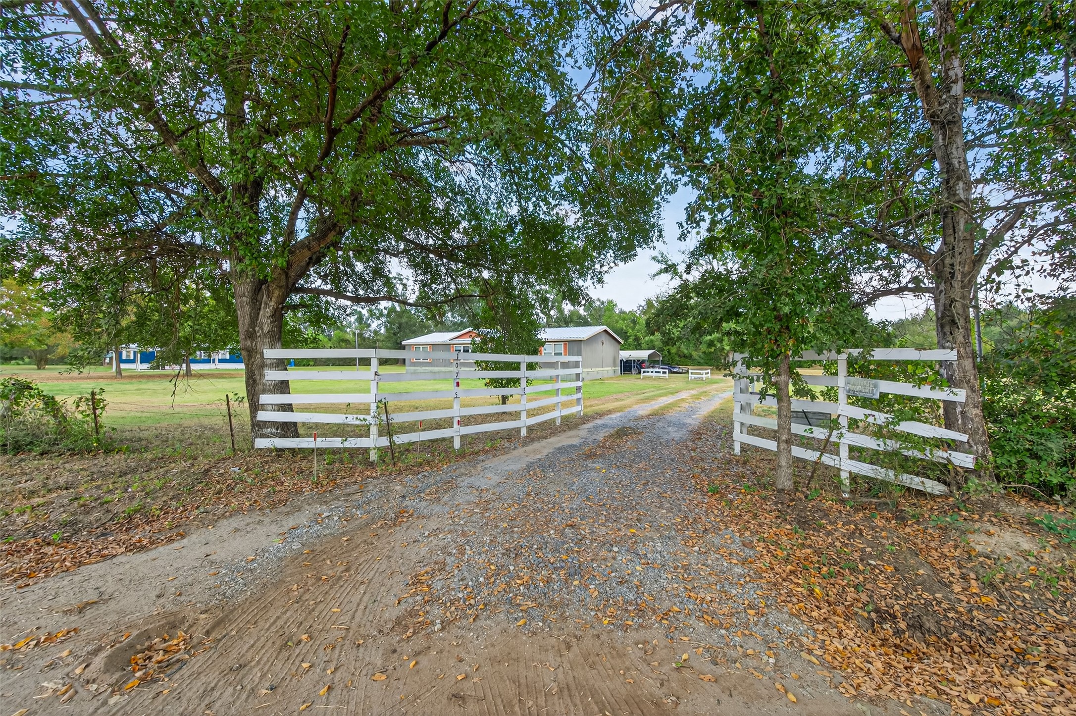10715 Bozeman Ferry Road Midway, TX 75852 - Photo 44 of 50 Beautiful white fenced gates open to a peaceful driveway leading into 9.33 amazing acres