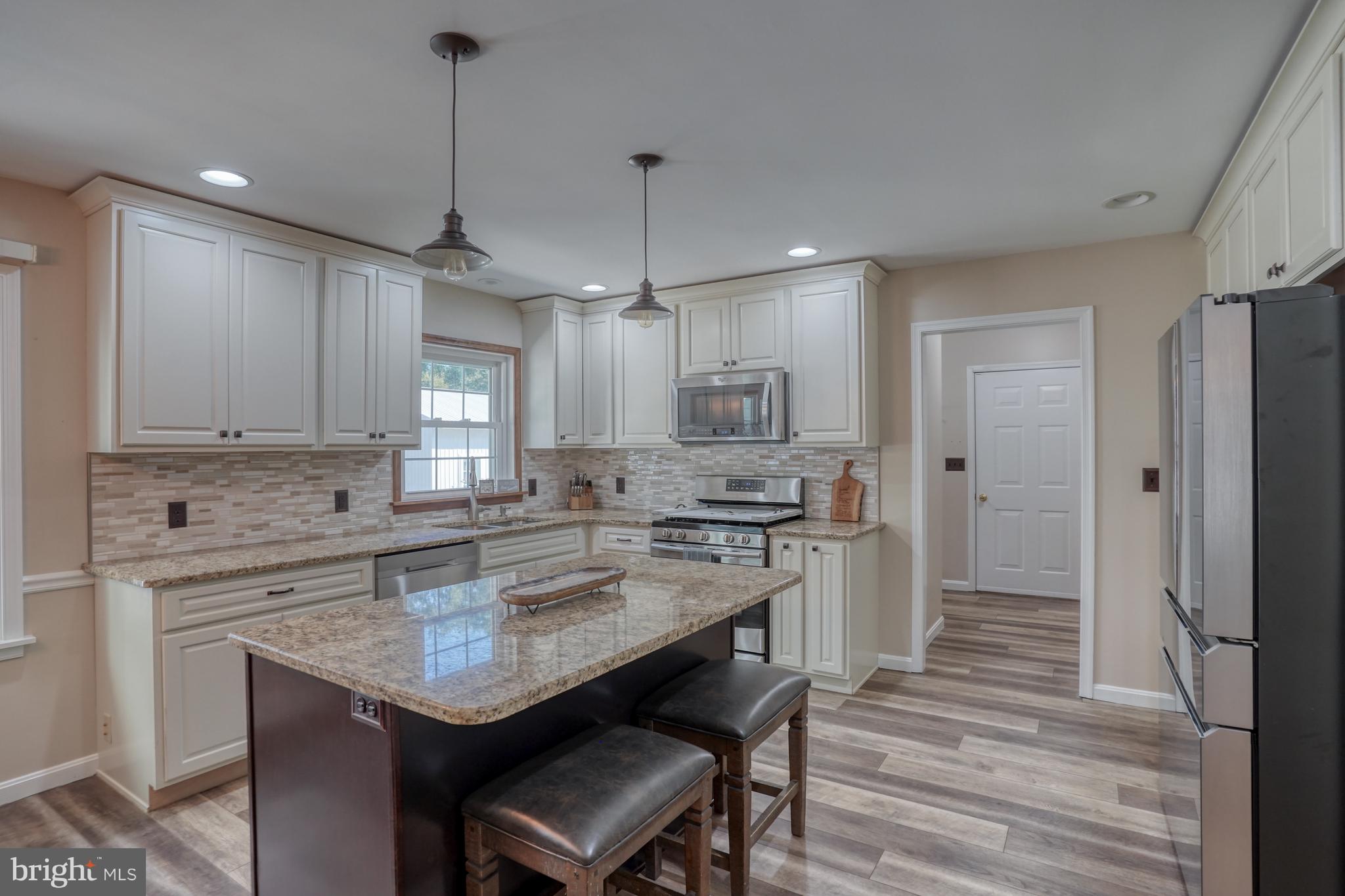 1051 Hartly Road Hartly, DE 19953 - Photo 34 of 47 a kitchen with a center island appliances and cabinets