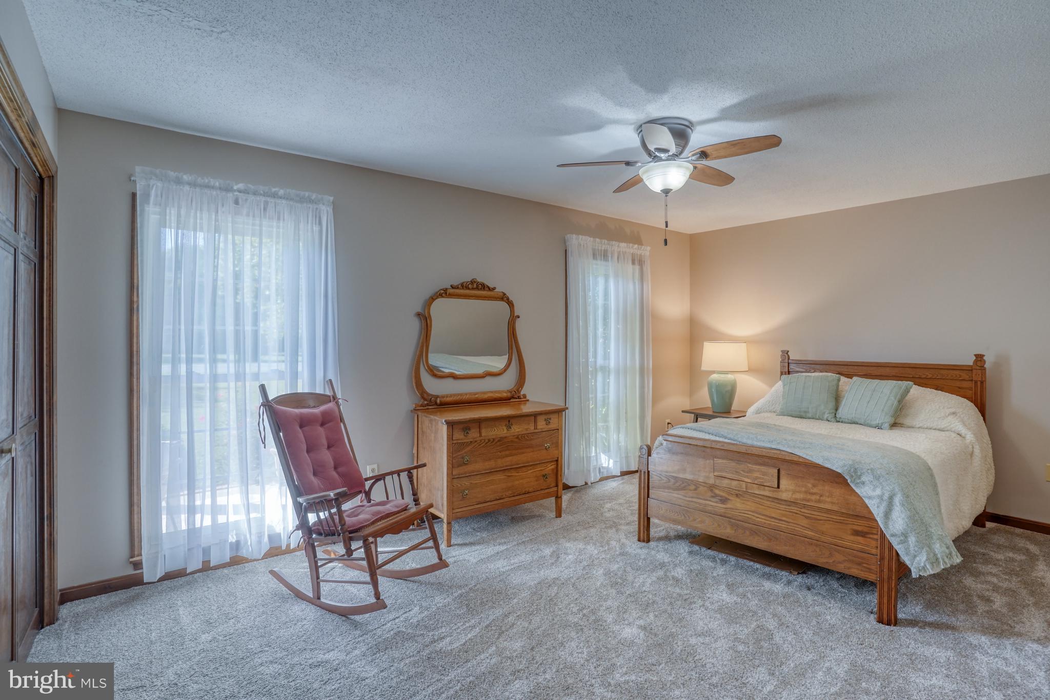 1051 Hartly Road Hartly, DE 19953 - Photo 43 of 47 a bedroom with a bed a chair and a chandelier