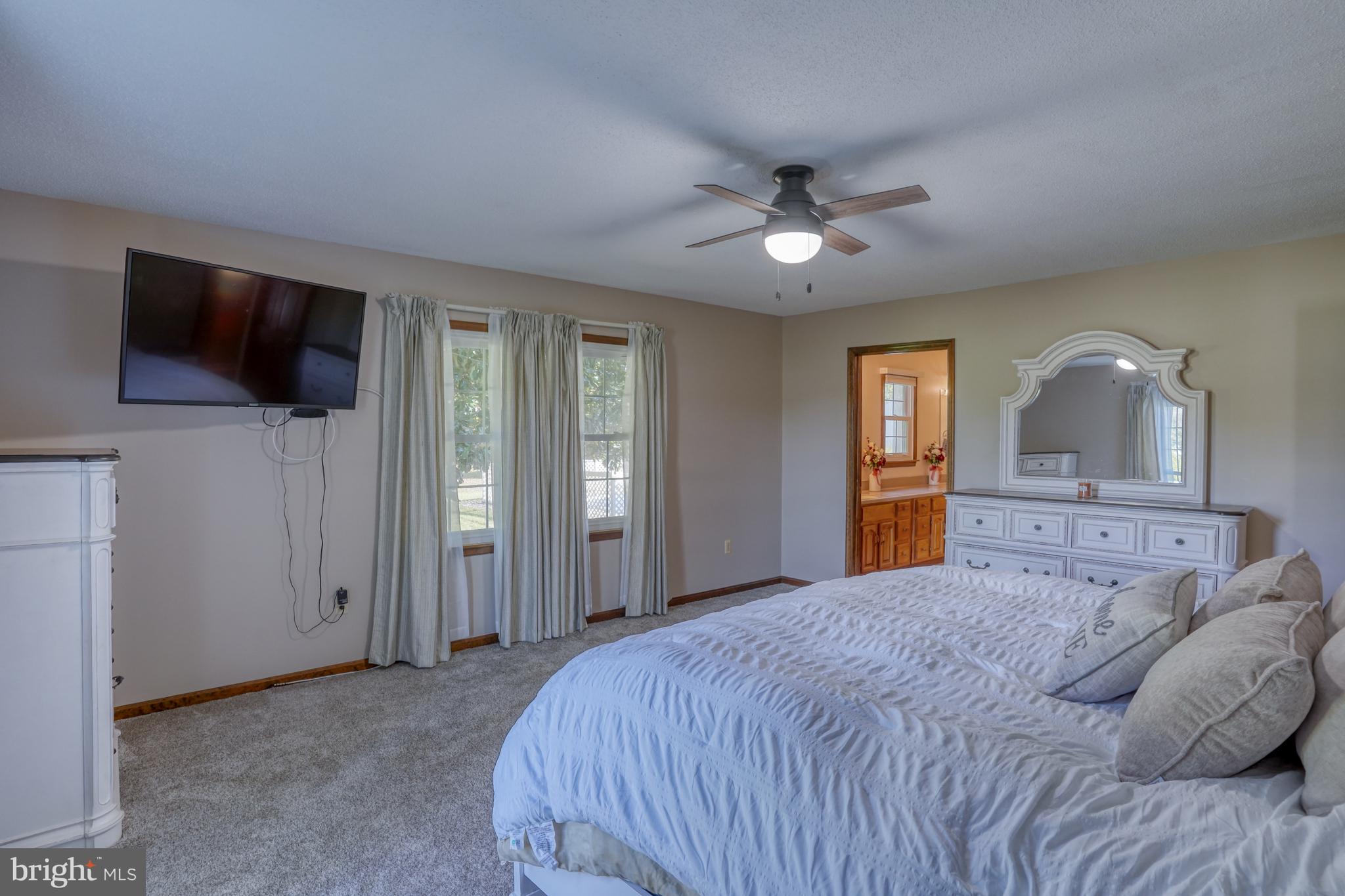 1051 Hartly Road Hartly, DE 19953 - Photo 46 of 47 a bedroom with a large bed a flat tv screen and dresser