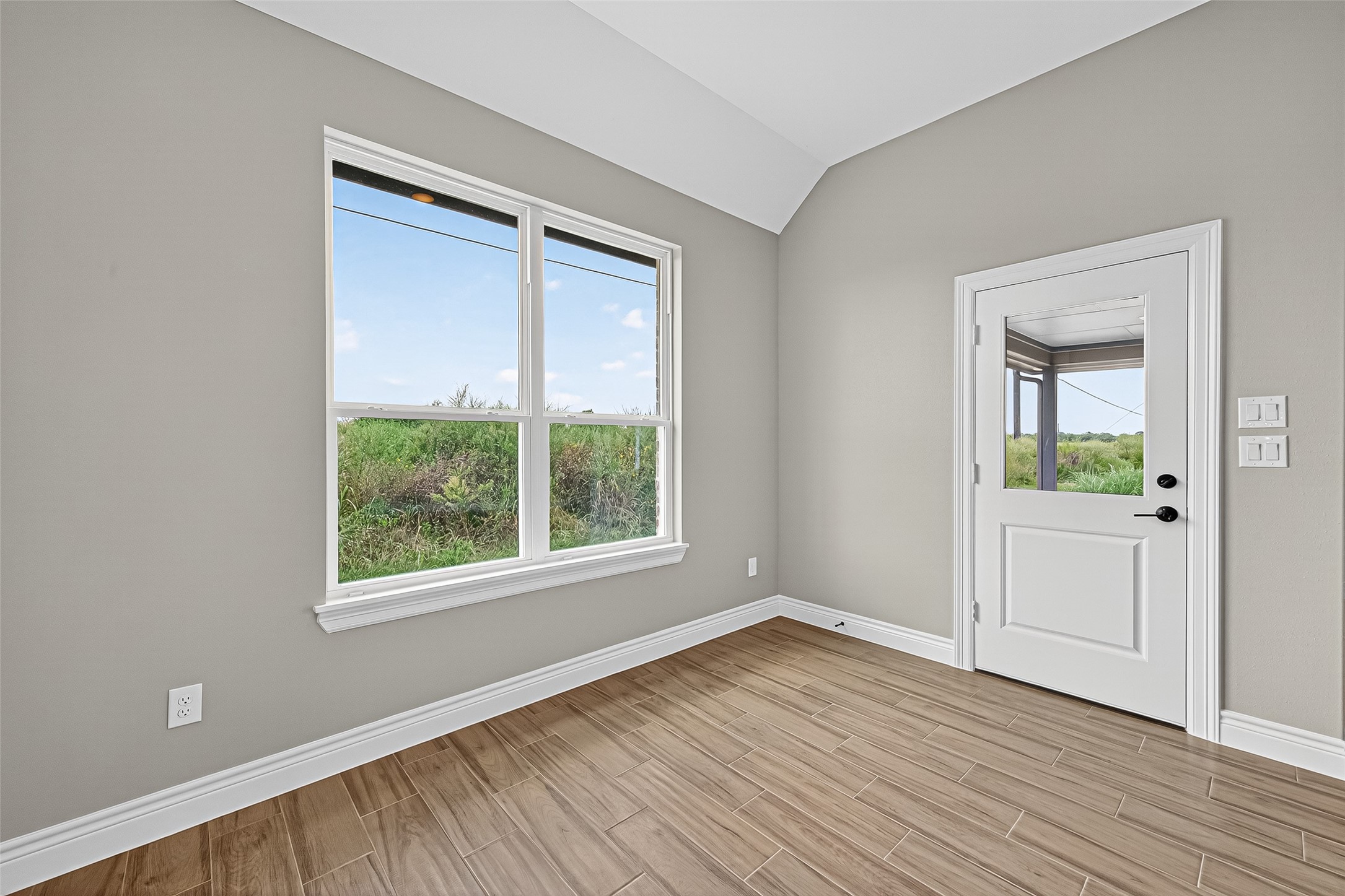 501 Oleander Street Hempstead, TX 77445 - Photo 11 of 48 an empty room with wooden floor and windows