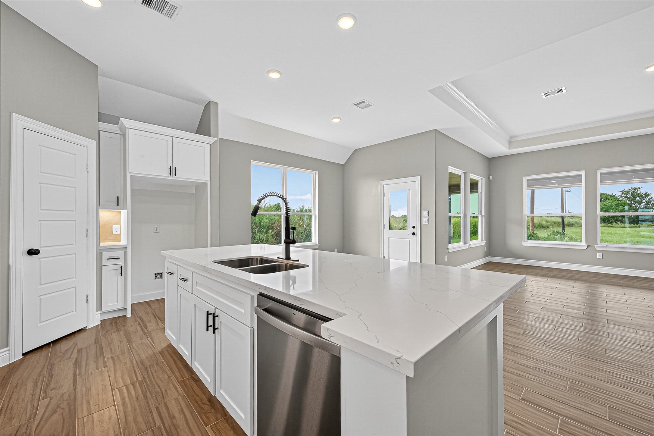 501 Oleander Street Hempstead, TX 77445 - Photo 20 of 48 a open kitchen with kitchen island a stove a sink and a wooden floors