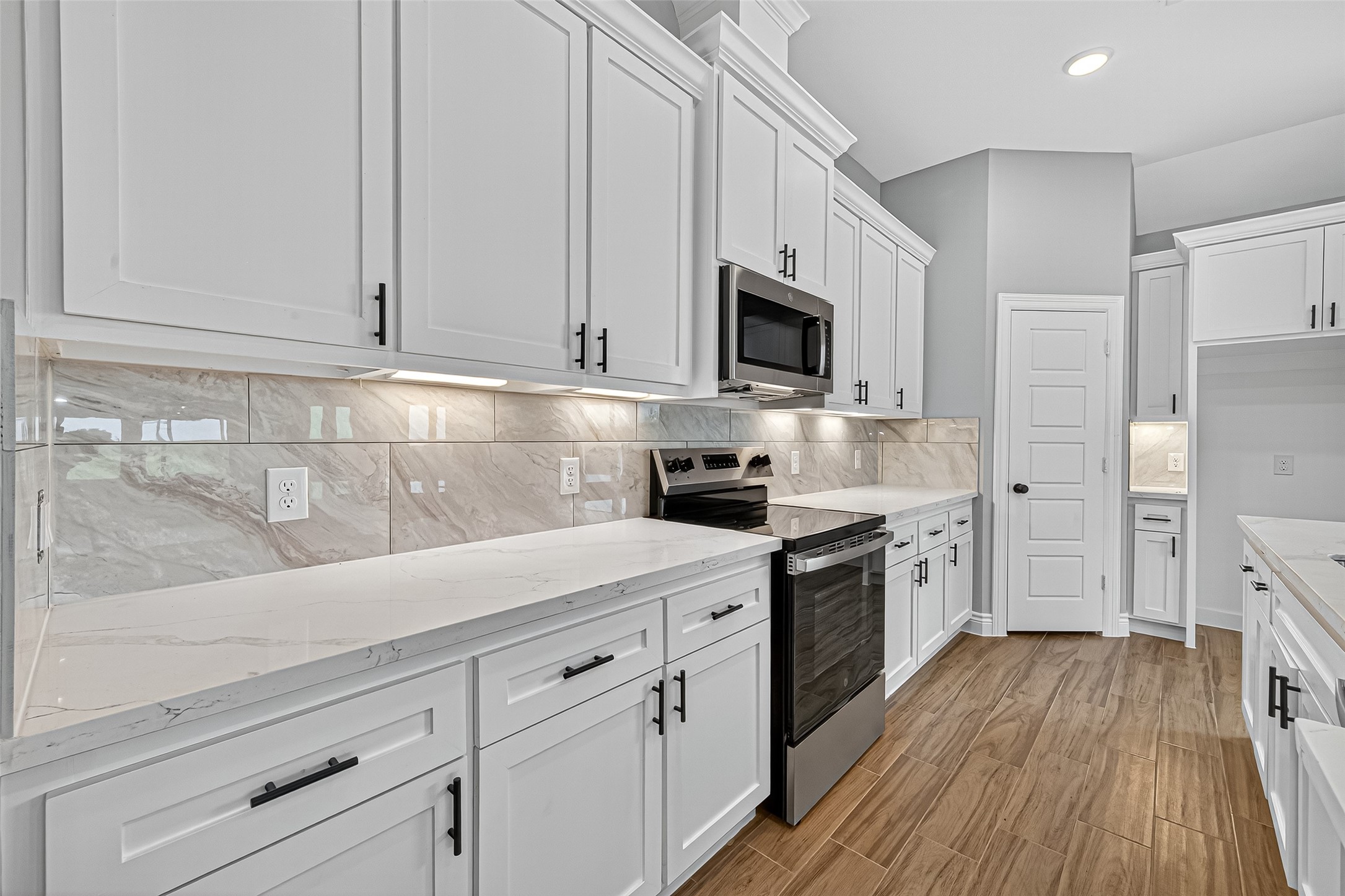 501 Oleander Street Hempstead, TX 77445 - Photo 22 of 48 a kitchen with white cabinets stainless steel appliances and sink